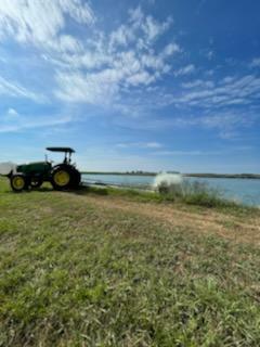 tractor in field near water